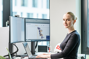 A young woman at a desk in an office