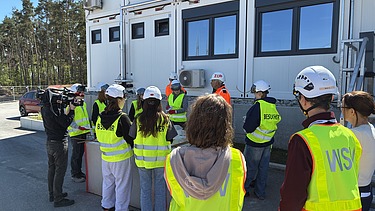 Children wearing high-visibility clothing on the Kriegenbrunn lock construction site