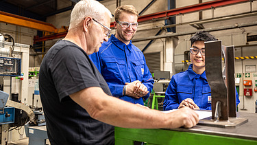 Two apprentices and a trainer in the workshop