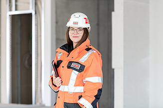 Photo of three people in protective clothing on a building site