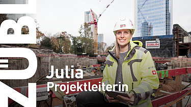 A close-up of a project manager wearing a ZÜBLIN hard hat.