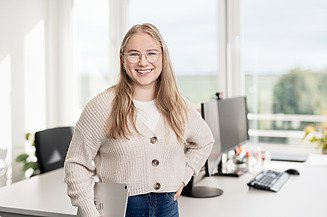 A young woman with an iPad in the office