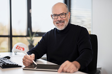 An employee using a tablet at a desk