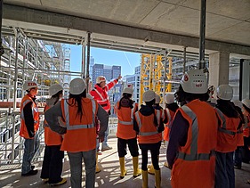 Children wearing high-visibility clothing on a building site