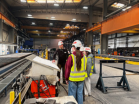 Children wearing high-visibility clothing at the steelworks