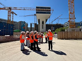 Children wearing high-visibility clothing on a building site