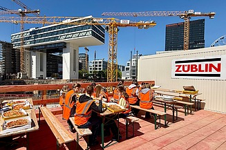 Children wearing high-visibility clothing on a building site