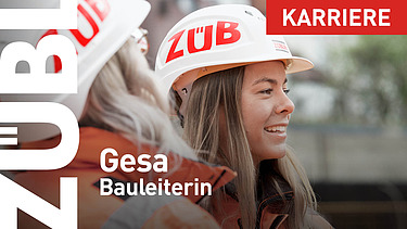 A close-up of a female site manager wearing a ZÜBLIN hard hat.