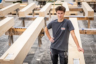 Employee amongst wooden elements