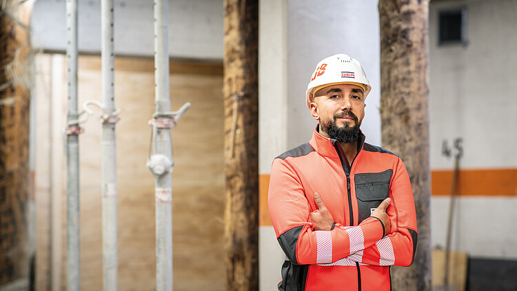 Workers on the building site with their arms crossed