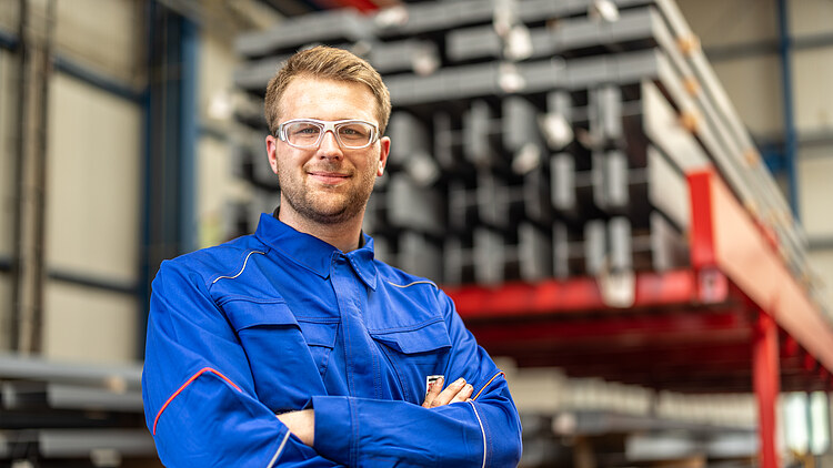 An apprentice is standing in a hall