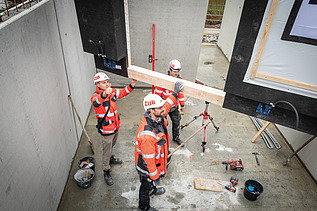 Staff working on a wooden component
