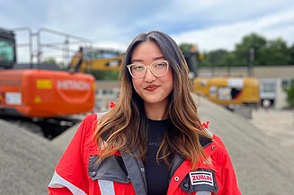 Trainee Anh Thu in safety clothing on the building site