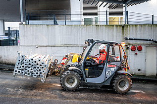 An employee operating a forklift on a building site