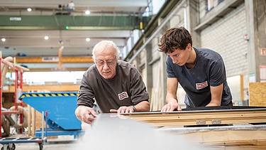 An apprentice working alongside his trainer