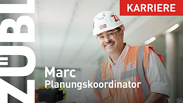 A close-up of a project manager wearing a ZÜBLIN hard hat.