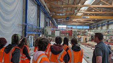 Children wearing protective workwear in the production hall in Aichach