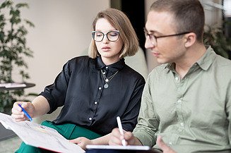 Two staff members in a meeting.