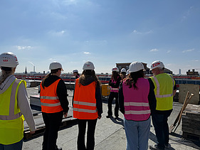 Children wearing high-visibility clothing on a building site