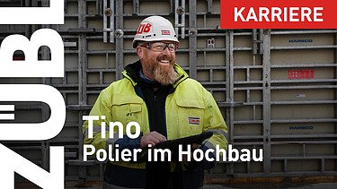 Mann mit Bart in Arbeitsschutzkleidung auf einer Großbaustelle