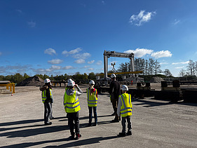 Children wearing high-visibility clothing at the Sande steelworks