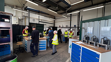 Children wearing high-visibility clothing at the steelworks
